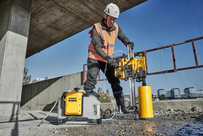 DEWALT DCE6820N, DCE6820N-XJ drilling tool in use at a construction site outdoors. Photography category.